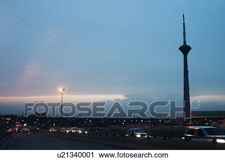 Stock Image - Traffic on road with Pitampura TV Tower, Delhi, India. Fotosearch