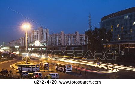 Stock Image - Traffic on the road at night, IFFCO Chowk, Gurgaon, Haryana. Fotosearch
