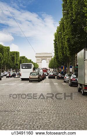 Stock Image - Traffic with triumphal arch in the background, Arc de Triomphe, Avenue des Champs-Elysees, Paris, France. Fotosearch