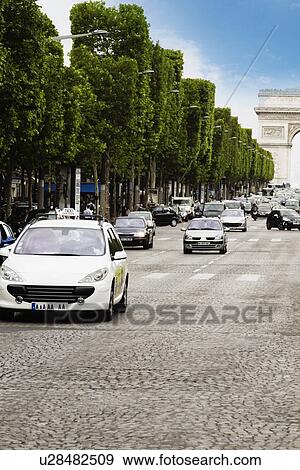 Stock Photo - Traffic with triumphal arch in the background, Arc de Triomphe, Avenue des Champs-Elysees, Paris, France. Fotosearch