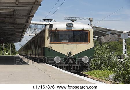 Stock Photograph - Train at a railroad station, Kanchipuram, Tamil Nadu, India. Fotosearch
