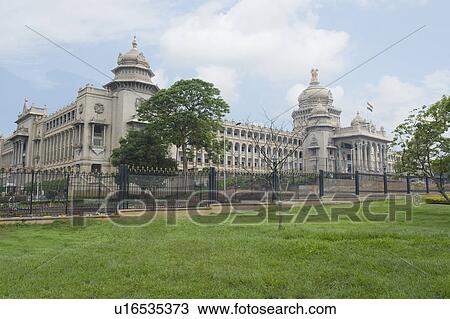 Stock Image - Trees in front of a government building, Vidhana Soudha, Bangalore, Karnataka, India. Fotosearch