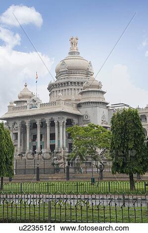 Stock Image - Trees in front of a government building, Vidhana Soudha, Bangalore, Karnataka, India. Fotosearch
