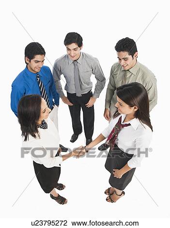 Stock Image - Two businesswomen shaking hands. Fotosearch