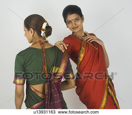 Two female folk dancers standing together in traditional Maharashtrian dress View Large Photo Image Stock Image - Two female folk dancers standing together in traditional Maharashtrian dress. Fotosearch