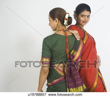 Two female folk dancers standing together in traditional Maharashtrian dress View Large Photo Image Stock Photo - Two female folk dancers standing together in traditional Maharashtrian dress. Fotosearch