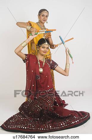 Picture - Two women performing dandiya. Fotosearch