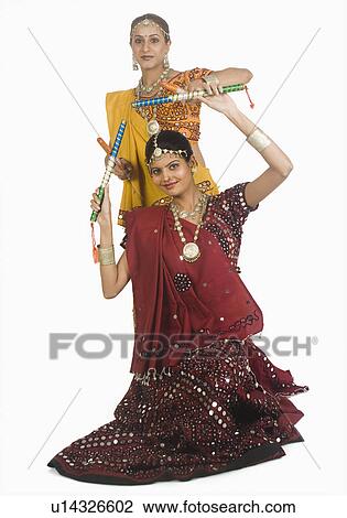Two women performing dandiya View Large Photo Image Stock Image - Two women performing dandiya. Fotosearch