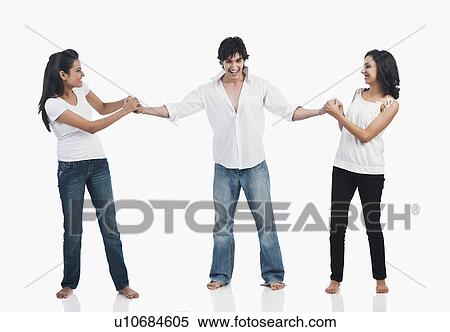 Stock Photography - Two women pulling a men. Fotosearch