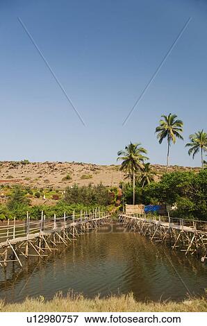 Stock Photo - Two wooden bridges across the river, Goa, India. Fotosearch