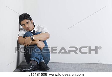 Stock Photograph - University student sitting in the corner. Fotosearch