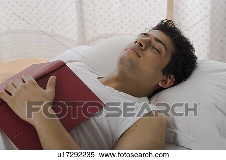 University student sleeping with a book on the bed View Large Photo Image Stock Photography - University student sleeping with a book on the bed. Fotosearch