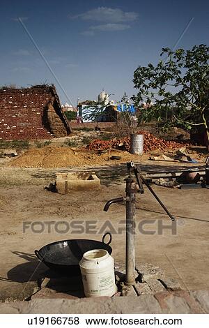 Stock Photo - Water pump with the mausoleum in the background, Taj Mahal, Agra, Uttar Pradesh, India. Fotosearch