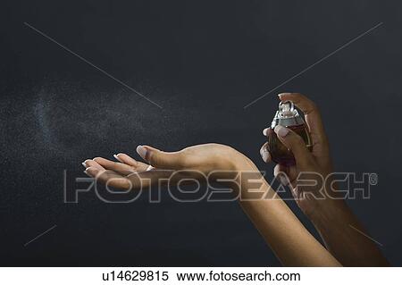 Woman applying perfume on her hand View Large Photo Image Stock Photography - Woman applying perfume on her hand. Fotosearch