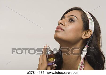 Woman applying perfume View Large Photo Image Stock Photography - Woman applying perfume. Fotosearch