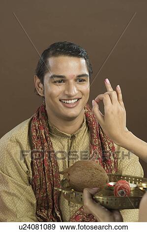 Woman applying tilak on her brother's forehead at Raksha Bandhan festival View Large Photo Image Stock Photo - Woman applying tilak on her brother's forehead at Raksha Bandhan festival. Fotosearch