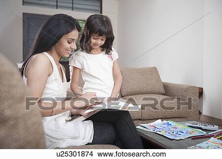 Woman assisting her daughter in drawing View Large Photo Image Picture - Woman assisting her daughter in drawing. Fotosearch