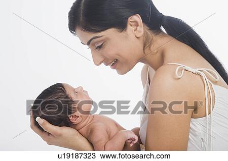 Woman carrying her baby and smiling View Large Photo Image Stock Image - Woman carrying her baby and smiling. Fotosearch