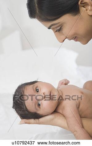 Woman carrying her baby and smiling View Large Photo Image Stock Photo - Woman carrying her baby and smiling. Fotosearch