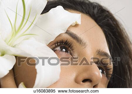 Woman day dreaming with a flower View Large Photo Image Stock Photography - Woman day dreaming with a flower. Fotosearch