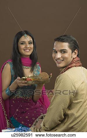 Woman doing aarti of her brother at the festival of Rakhi View Large Photo Image Stock Image - Woman doing aarti of her brother at the festival of Rakhi. Fotosearch