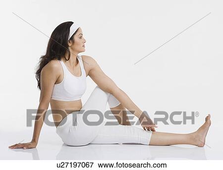 Stock Photo - Woman doing Arch Matsyendrasana (Half Spinal Twist). Fotosearch