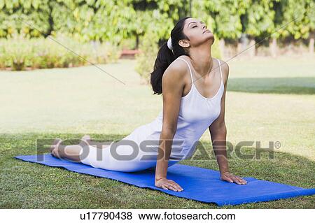Stock Photo - Woman doing Bhujangasana (Cobra Pose). Fotosearch