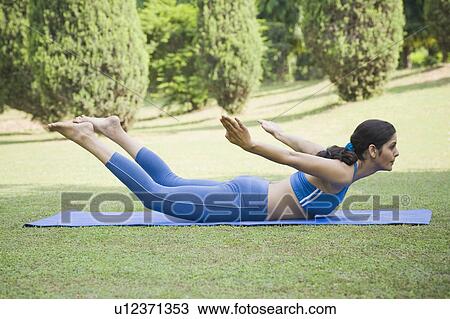 Woman doing Dhanurasana (Bow Pose) View Large Photo Image Stock Image - Woman doing Dhanurasana (Bow Pose). Fotosearch