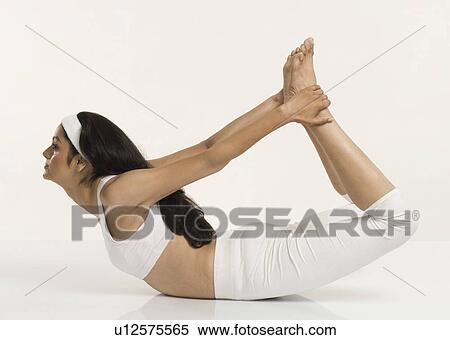 Stock Photography - Woman doing Dhanurasana (Bow Pose). Fotosearch