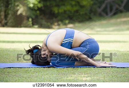 Woman doing Shashankasana pose (Hare Pose) View Large Photo Image Picture - Woman doing Shashankasana pose (Hare Pose). Fotosearch