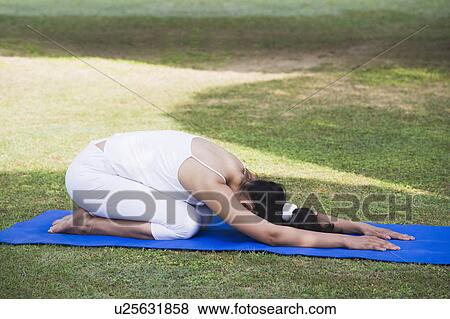 Woman doing Shashankasana pose (Hare Pose) View Large Photo Image Stock Photo - Woman doing Shashankasana pose (Hare Pose). Fotosearch