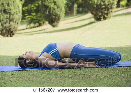 Stock Photo - Woman doing Supta Vajrasana (Reclining Adamant Pose). Fotosearch
