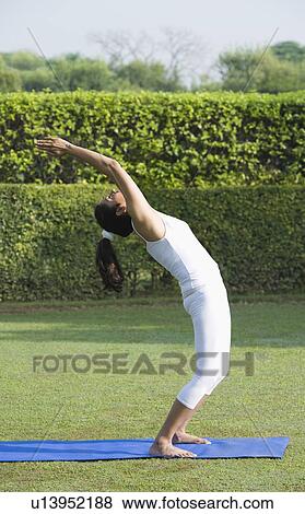 Stock Photo - Woman doing Surya Namaskar (Sun Slautation). Fotosearch