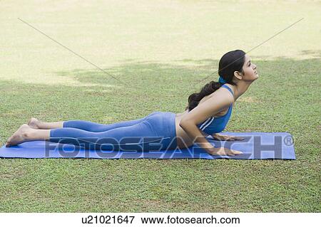 Stock Photo - Woman doing Surya Namaskar (Sun Slautation). Fotosearch