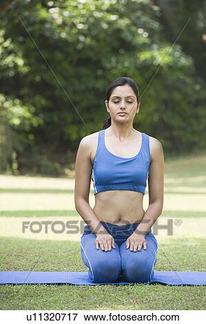 Stock Photo - Woman doing Vajrasana (Thunderbolt Pose). Fotosearch