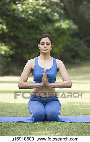 Stock Photo - Woman doing Vajrasana (Thunderbolt Pose). Fotosearch