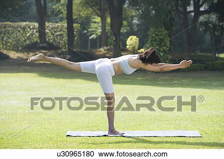 Woman doing Veerasana (Warrior Pose) View Large Photo Image Stock Image - Woman doing Veerasana (Warrior Pose). Fotosearch