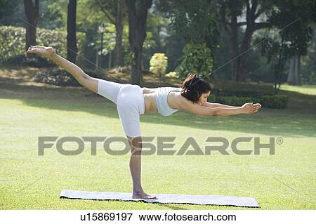 Stock Photo - Woman doing Veerasana (Warrior Pose). Fotosearch