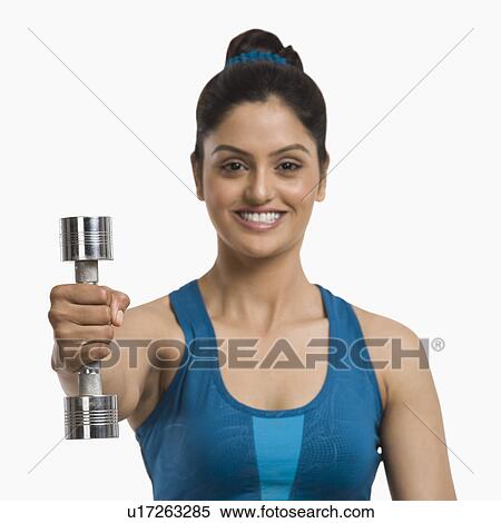 Woman exercising with a dumbbell View Large Photo Image Stock Photography - Woman exercising with a dumbbell. Fotosearch