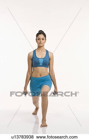 Woman exercising with dumbbells View Large Photo Image Stock Photo - Woman exercising with dumbbells. Fotosearch