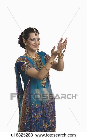 Stock Image - Woman gesturing at Diwali festival. Fotosearch