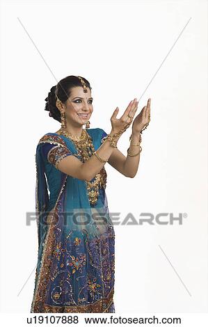 Stock Photo - Woman gesturing at Diwali festival. Fotosearch
