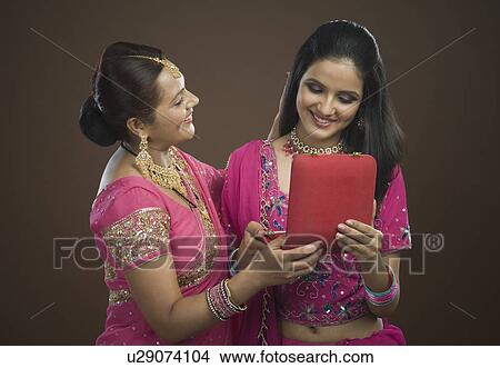 Picture - Woman giving a present to her daughter. Fotosearch