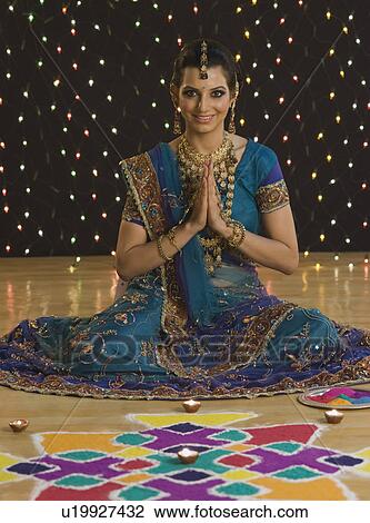 Woman greeting in prayer position near rangoli at Diwali festival View Large Photo Image Stock Image - Woman greeting in prayer position near rangoli at Diwali festival. Fotosearch