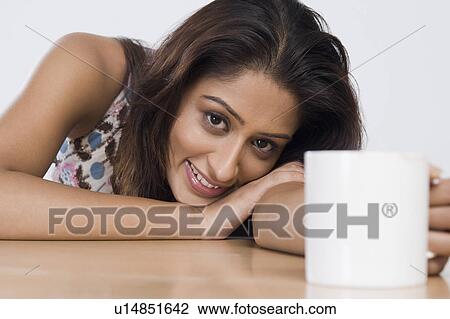 Woman holding a cup of coffee View Large Photo Image Stock Image - Woman holding a cup of coffee. Fotosearch