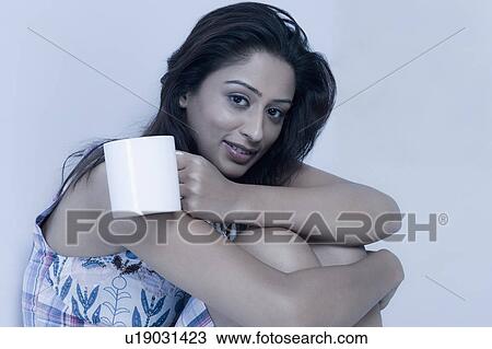 Woman holding a cup of coffee View Large Photo Image Stock Image - Woman holding a cup of coffee. Fotosearch