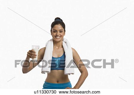 Woman holding a glass of milk and smiling View Large Photo Image Stock Image - Woman holding a glass of milk and smiling. Fotosearch