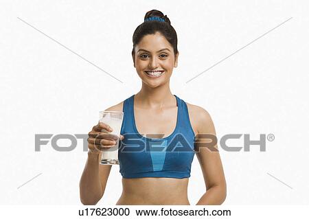 Woman holding a glass of milk and smiling View Large Photo Image Stock Image - Woman holding a glass of milk and smiling. Fotosearch