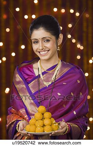 Woman holding a plate full of sweets View Large Photo Image Stock Image - Woman holding a plate full of sweets. Fotosearch