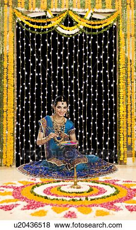 Woman holding a plate of powder paints to make rangoli at Diwali festival View Large Photo Image Stock Photo - Woman holding a plate of powder paints to make rangoli at Diwali festival. Fotosearch